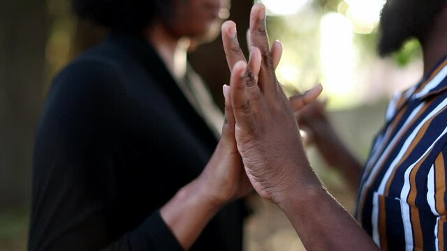 Hands joining together in union. Married black African couple