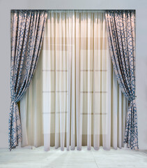 Modern design of window and doorways. Luxurious gray curtains with blue geometric ornamentand light tulle from translucent organza