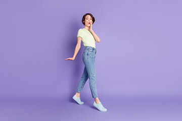 Fototapeta na wymiar Full length body size profile side view of lovely amazed girl jumping going pout lips isolated over violet color background