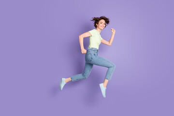 Fototapeta na wymiar Full length body size profile side view of lovely cheerful sporty girl jumping running marathon isolated over violet color background