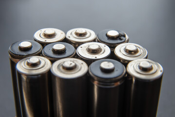 Batteries arranged side by side, on a dark surface. Batteries, energy and respect for the...