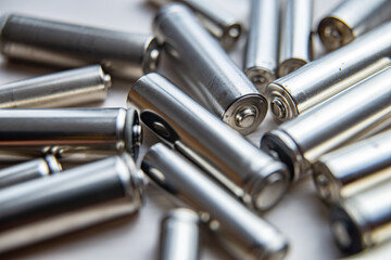 Batteries arranged next to each other on a light surface. Batteries, energy and respect for the...