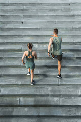 Sportive couple during workout stair running outdoors