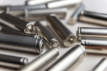 Batteries arranged next to each other on a light surface. Batteries, energy and respect for the...