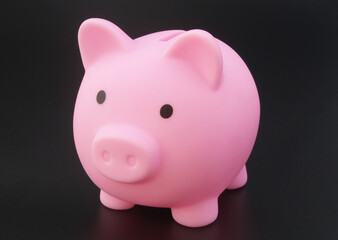 Piggy bank on black table close up