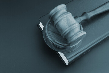 Wooden judge gavel on legal book. Justice and court concept.