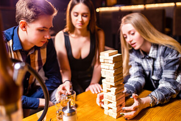 Young people have fun playing board games at a table