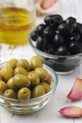 Black and green olives in glass bowls