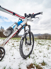 Biking in winter landscape on white mountain bike, extreme riding