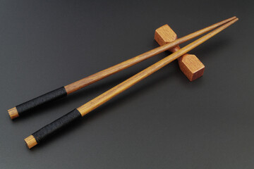 Wooden chopsticks on black table with copy space.