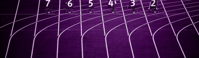 Starting blocks in track and field. Professional sport concept. Purple color filter