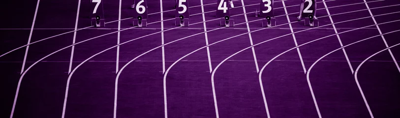 Papier Peint photo Chemin de fer Starting blocks in track and field. Professional sport concept. Purple color filter