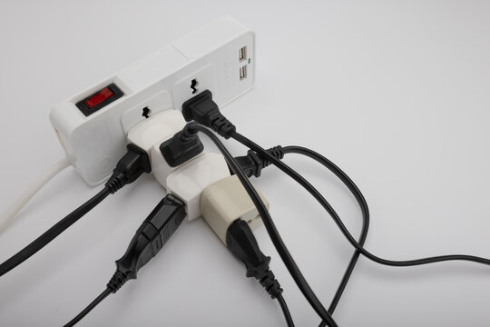 Multiple power socket with connected plugs , Multi plug electrical power strip on a white background , Unsafety concept