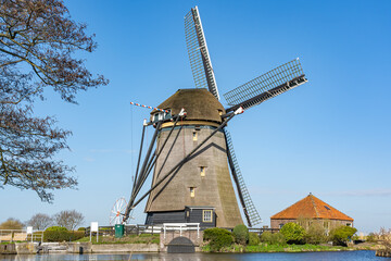 Photo of a stately old windmill under a clear blue sky on the Papenvaart near Hazerswoude-dorp, the Netherlands