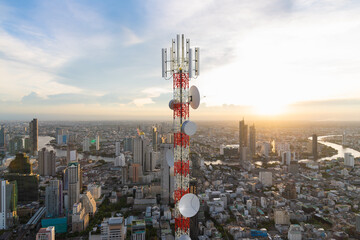 Telecommunication tower with 5G cellular network antenna on city sunset background