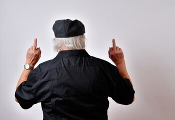 Senior man showing contempt with his back to the camera and both hands showing the middle fingers