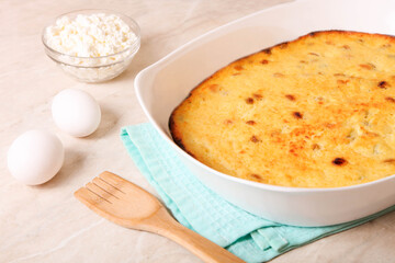 Cottage cheese casserole in a baking dish with ingredients
