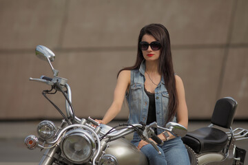 Portrait of young woman on a motorcycle