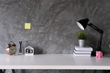 Cropped shot of minimal workspace with mock-up laptop, smartphone, decorations and copy space, work from home concept