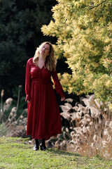 Obraz na płótnie Canvas woman portrait outdoors with red dress