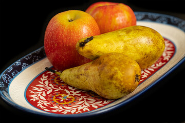 Fresh apples and pears on a decorative plate