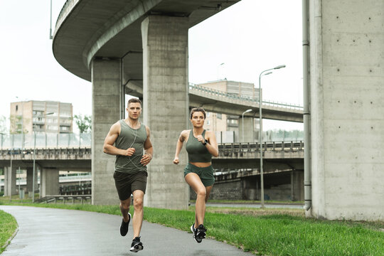 Sportive Couple During Jogging Workout On City Street