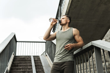 Muscular man after jogging workout on a city street