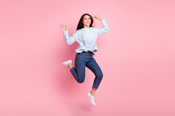 Fototapeta na wymiar Full size profile photo of nice optimistic long hairdo brunette lady jump wear blue sweater isolated on pink background