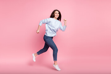 Fototapeta na wymiar Full size profile photo of nice optimistic long hairdo brunette lady jump run wear blue sweater isolated on pink background