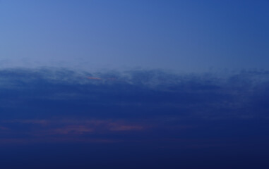 Fototapeta na wymiar beautiful sunset sky, twilight, dark silhouette of clouds as a background