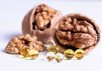 Ripe walnuts and capsules with a vitamin