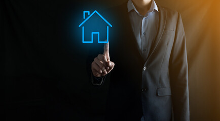 Real estate concept, businessman holding a house icon.House on Hand.Property insurance and security concept. Protecting gesture of man and symbol of house.