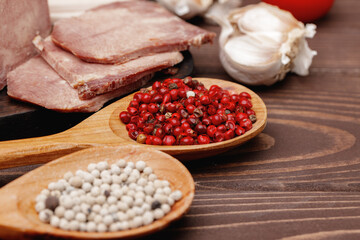 Assortment of meat and sausage on wooden surface