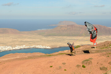 Man during departure with his parapent at Mirador del Rio on Lanzarote island in Spain