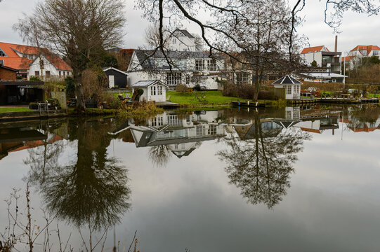 The town's houses are reflected in the lake, by the town of Ry, DK