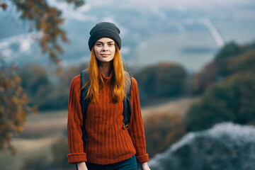 woman hiker with backpack in the mountains freedom landscape fresh air traveled