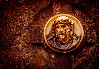 Marble portrait of Jesus with thorn crown on an old grave stone