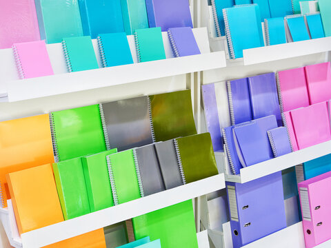 Colorful notebooks on shelf in store
