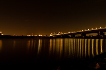 Night wide city view of Nijmegen. Bridge at night, reflection in the water