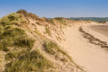 Sand dunes leading to the sea in a beach holiday setting