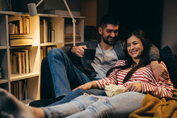 Fototapeta na wymiar couple relaxing at home watching television