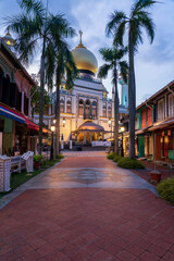 Fototapeta na wymiar Illuminated Arab street and Masjid Sultan Mosque with no people during city lock down at Kampong Glam, Singapore.