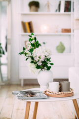 Vase with white flowers in the room