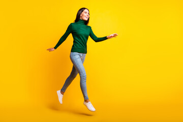 Full length profile side photo of charming lady walk jump up empty space isolated on shine yellow color background