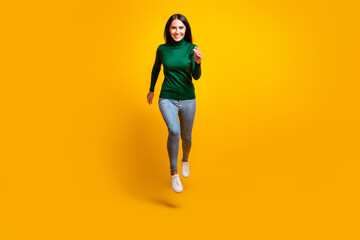 Fototapeta na wymiar Full length photo of charming active woman jump up run good mood sale isolated on shine yellow color background