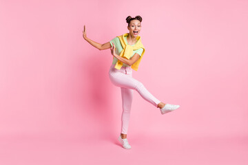 Fototapeta na wymiar Photo of sweet funny charming young woman wear green t-shirt dancing isolated pink color background