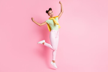 Photo of funny charming young woman wear green t-shirt jumping dancing isolated pink color background