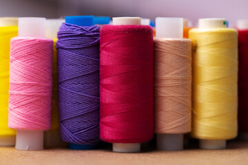 Many colored spools of threads as a background