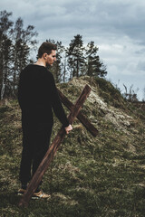 The man carries the cross. Сarry the cross. Man believes in God. Hope in God.