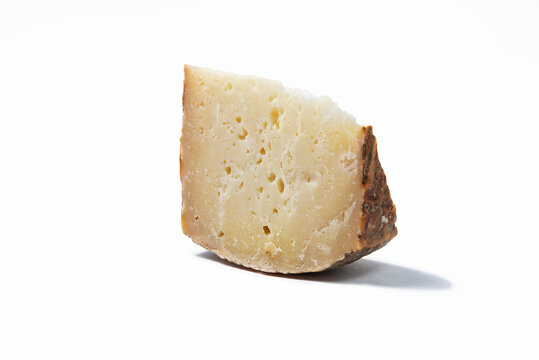 a piece of aged pecorino cheese in white background